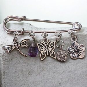 Silver Charm Brooch with Butterfly and Flower Accents